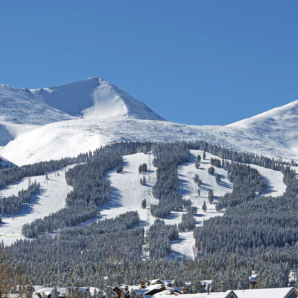 Colorado ski area with snow on mountain on sunny day Ridder Law Denver Colorado