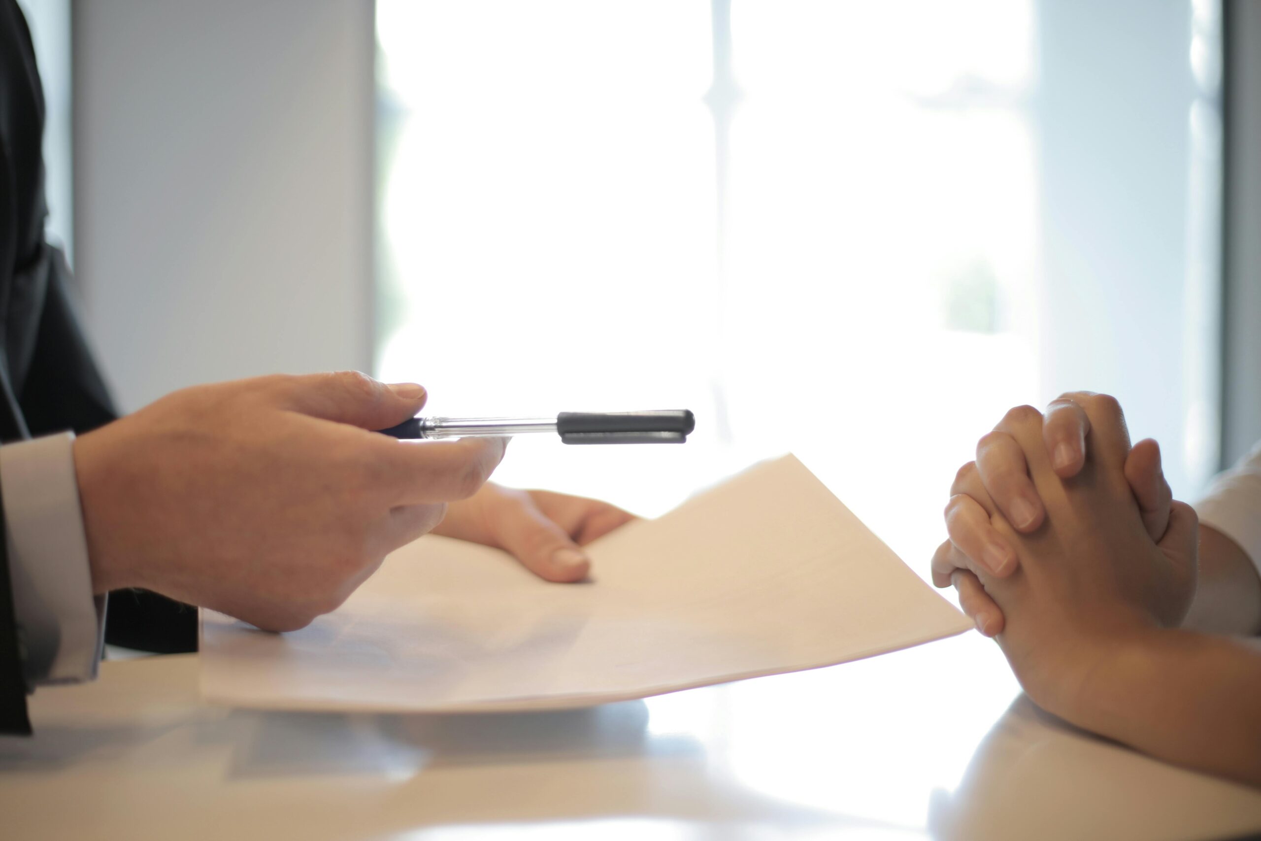 two people signing documents