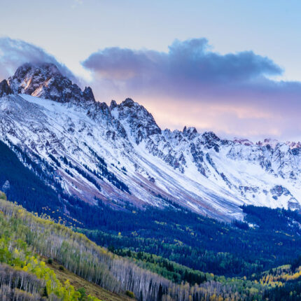 Mountain range with green trees in foreground Ridder Law Denver Colorado